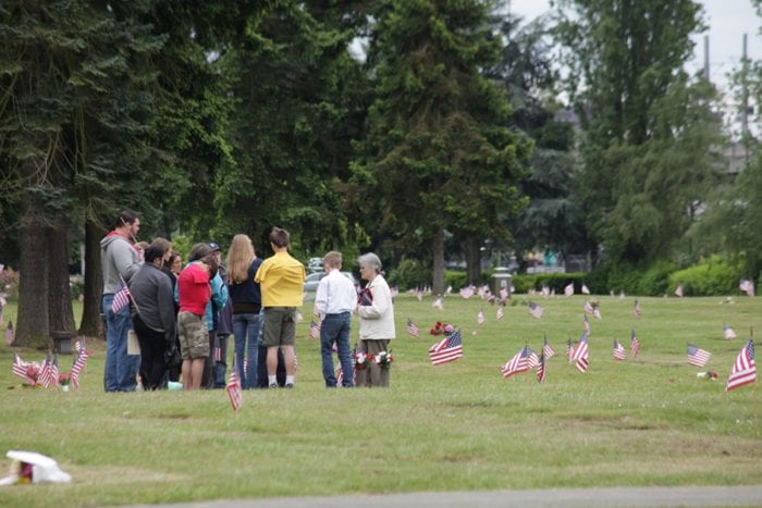 A group paying respects at a cemetary