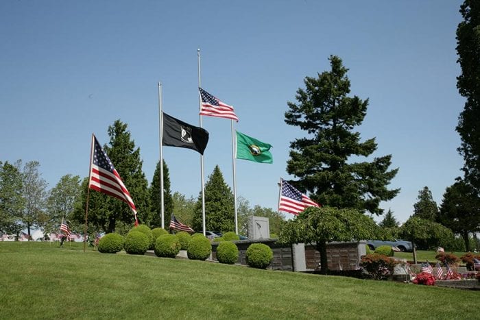 A row of flags at a cemetery