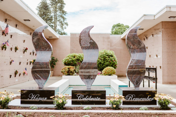 3 memorial statues sit side by side