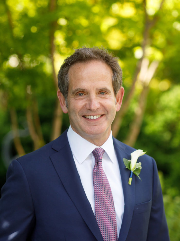 Anthony Shapiro smiles warmly wearing suit