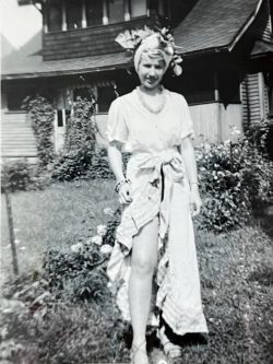 a woman standing in front of a house