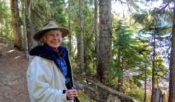 a woman hiking through the woods