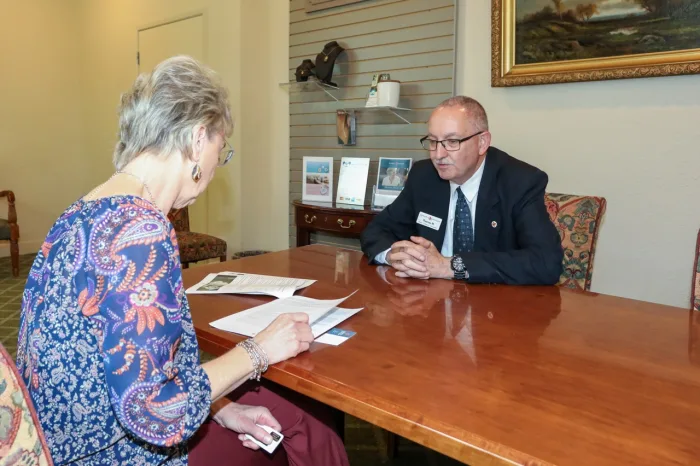 The team at Bonney Watson assists a customer with funeral preparations.